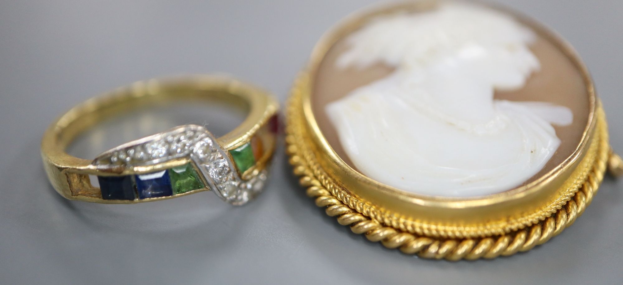 A modern 18ct gold and multi gem set ring, size L, (2 stones missing), gross 3.3 grams and cameo brooch